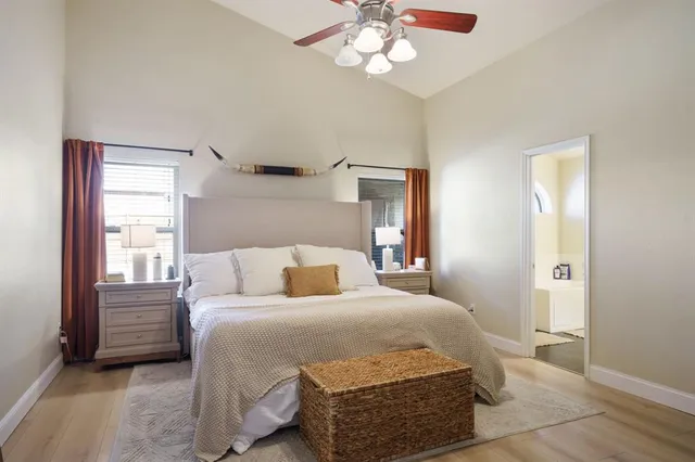 a kitchen with stainless steel appliances granite countertop a stove top oven a sink dishwasher and white cabinets next to a window