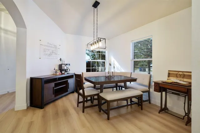 a dining room with furniture and window