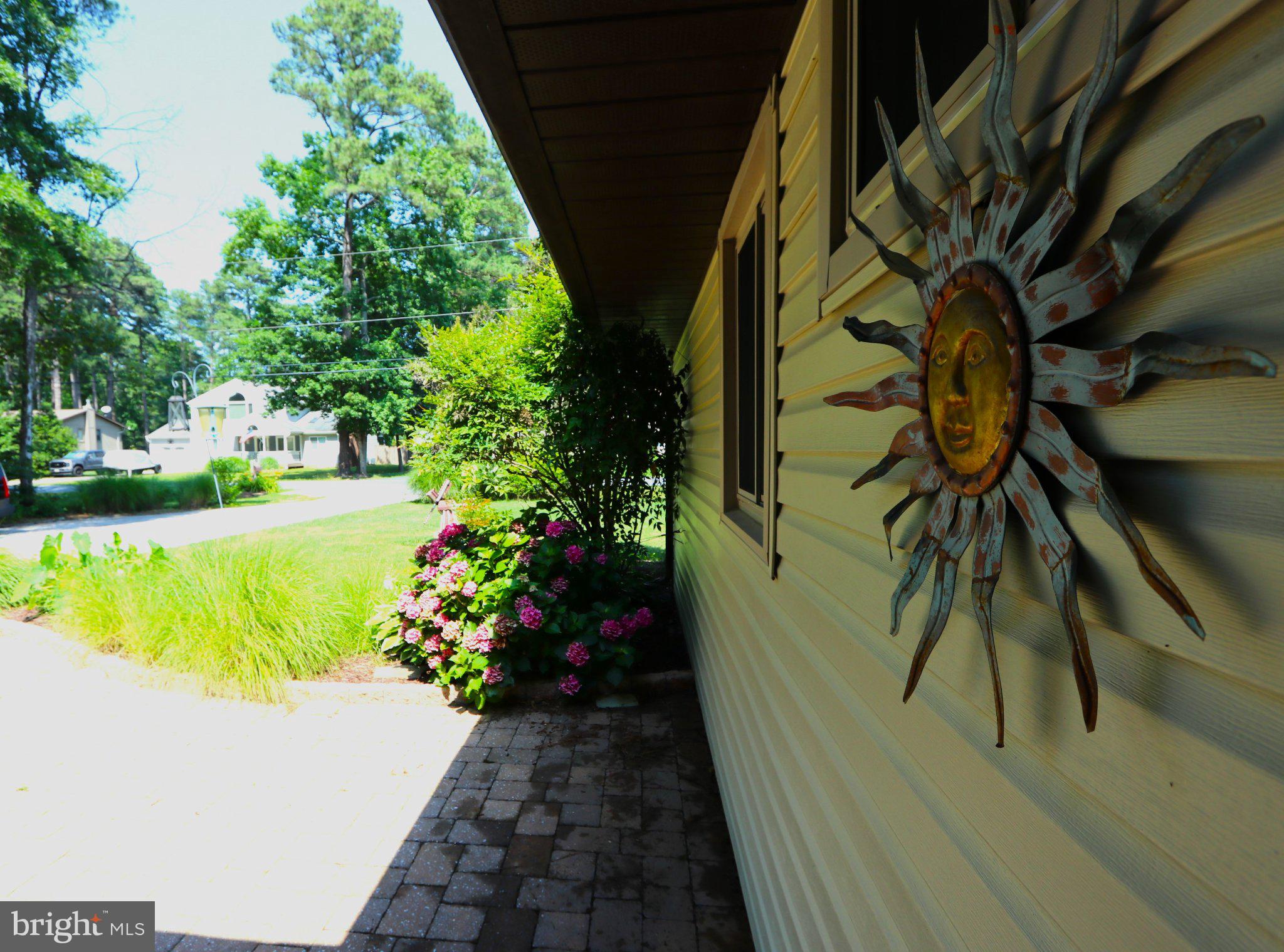 342 Wicomico Road Stevensville, MD 21666 - Photo 21 of 61 Charming entrance with vibrant blooms.