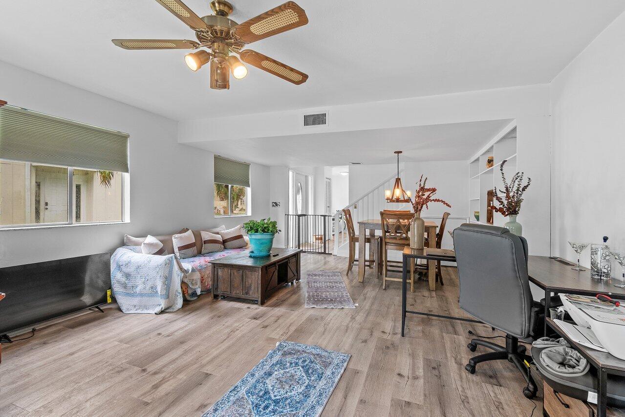 6199 Riverwalk Lane, Unit 6 Jupiter, FL 33458 - Photo 12 of 33 a living room with furniture and a wooden floor