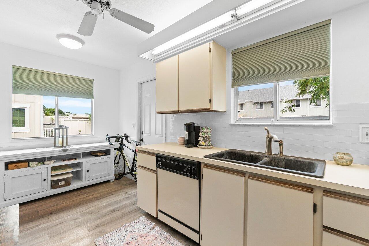 6199 Riverwalk Lane, Unit 6 Jupiter, FL 33458 - Photo 14 of 33 a kitchen with stainless steel appliances a sink a stove a refrigerator and cabinets