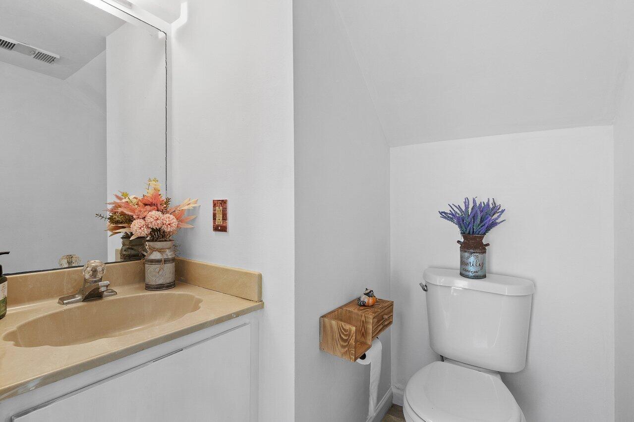 6199 Riverwalk Lane, Unit 6 Jupiter, FL 33458 - Photo 21 of 33 a bathroom with a sink mirror and toilet