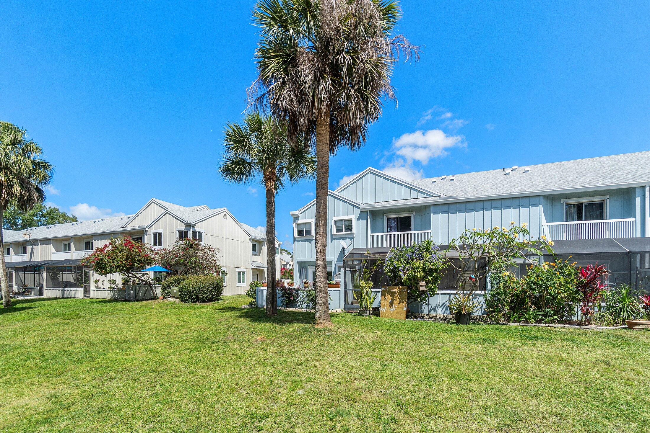 6199 Riverwalk Lane, Unit 6 Jupiter, FL 33458 - Photo 32 of 33 a front view of house with yard and green space