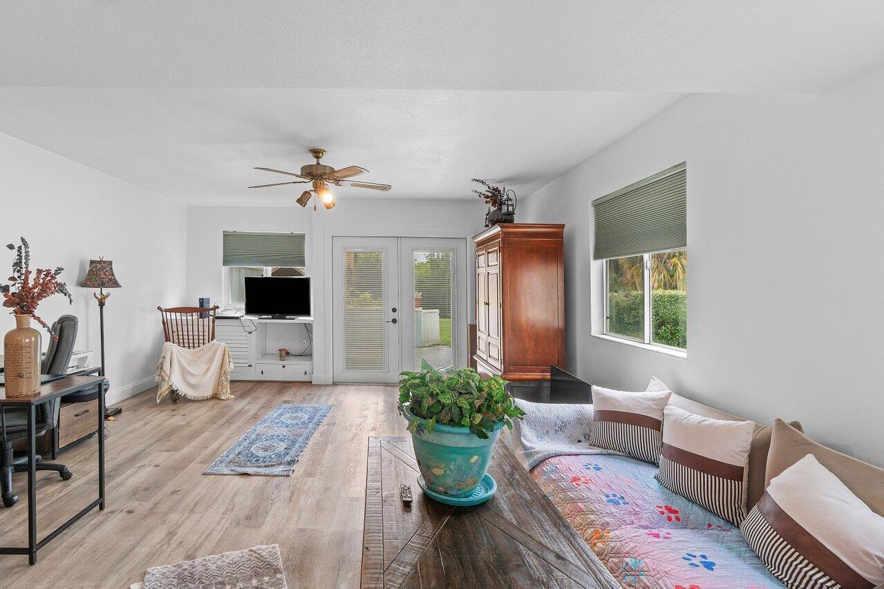 6199 Riverwalk Lane, Unit 6 Jupiter, FL 33458 - Photo 9 of 33 a living room with furniture and a large window
