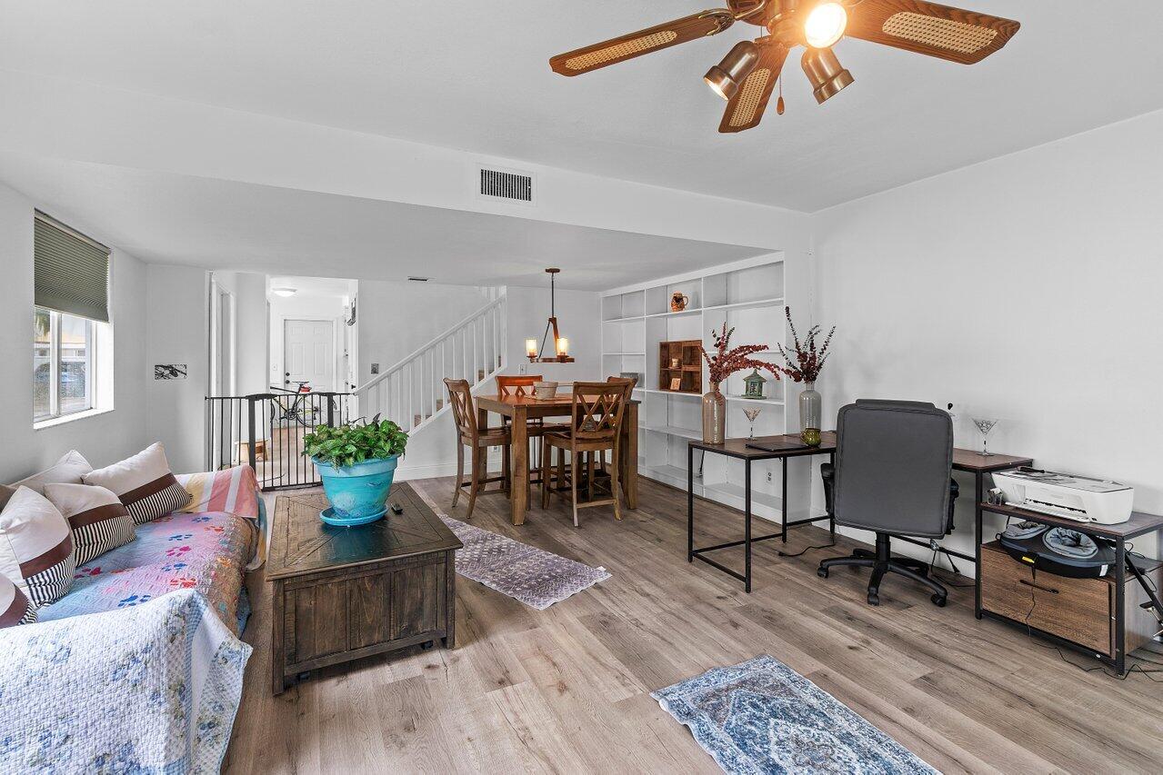 6199 Riverwalk Lane, Unit 6 Jupiter, FL 33458 - Photo 10 of 33 a living room with furniture and wooden floor