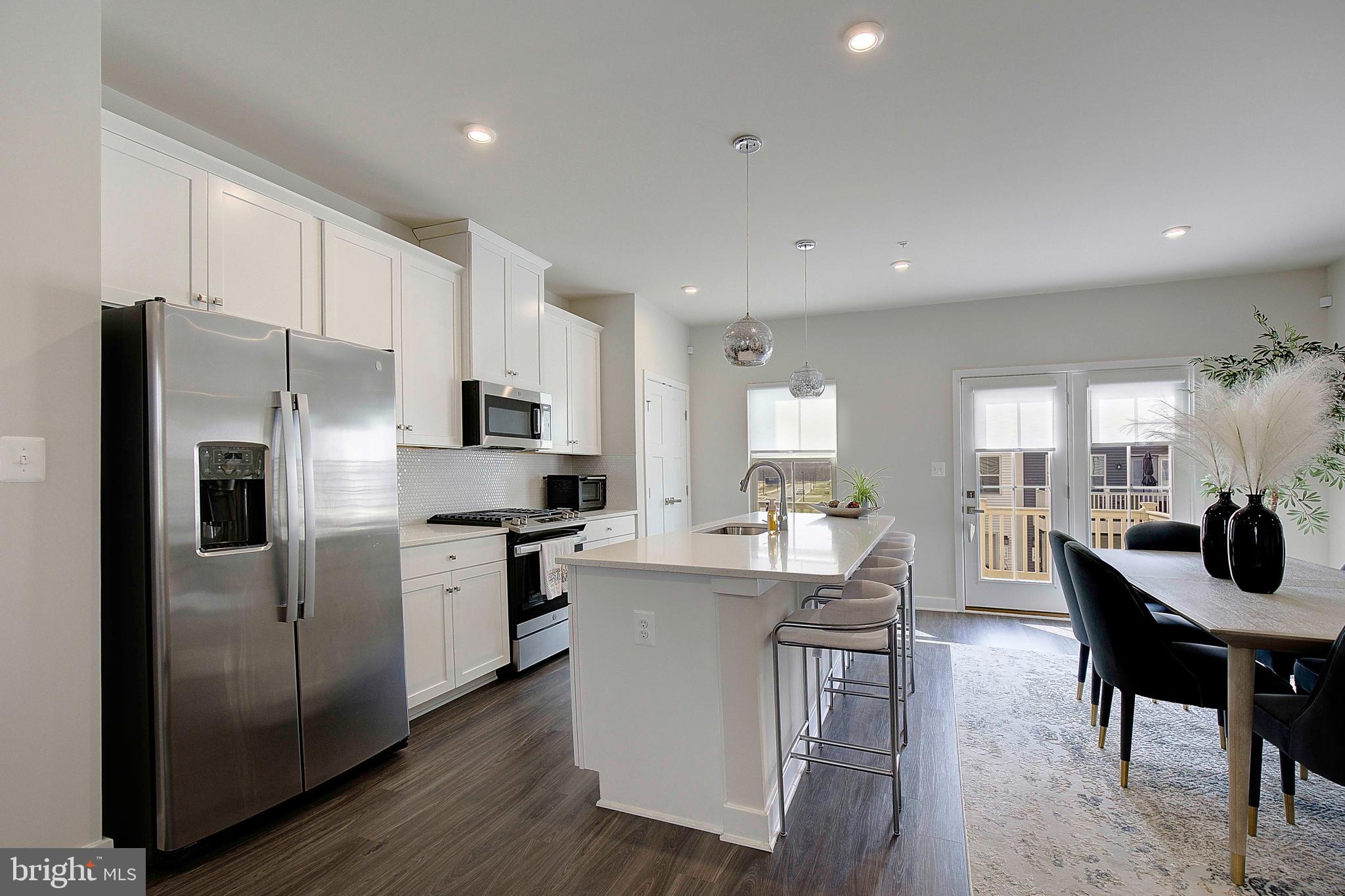 121 Swanson Creek Terrace Laurel, MD 20708 - Photo 14 of 31 a kitchen with a sink stainless steel appliances and white cabinets