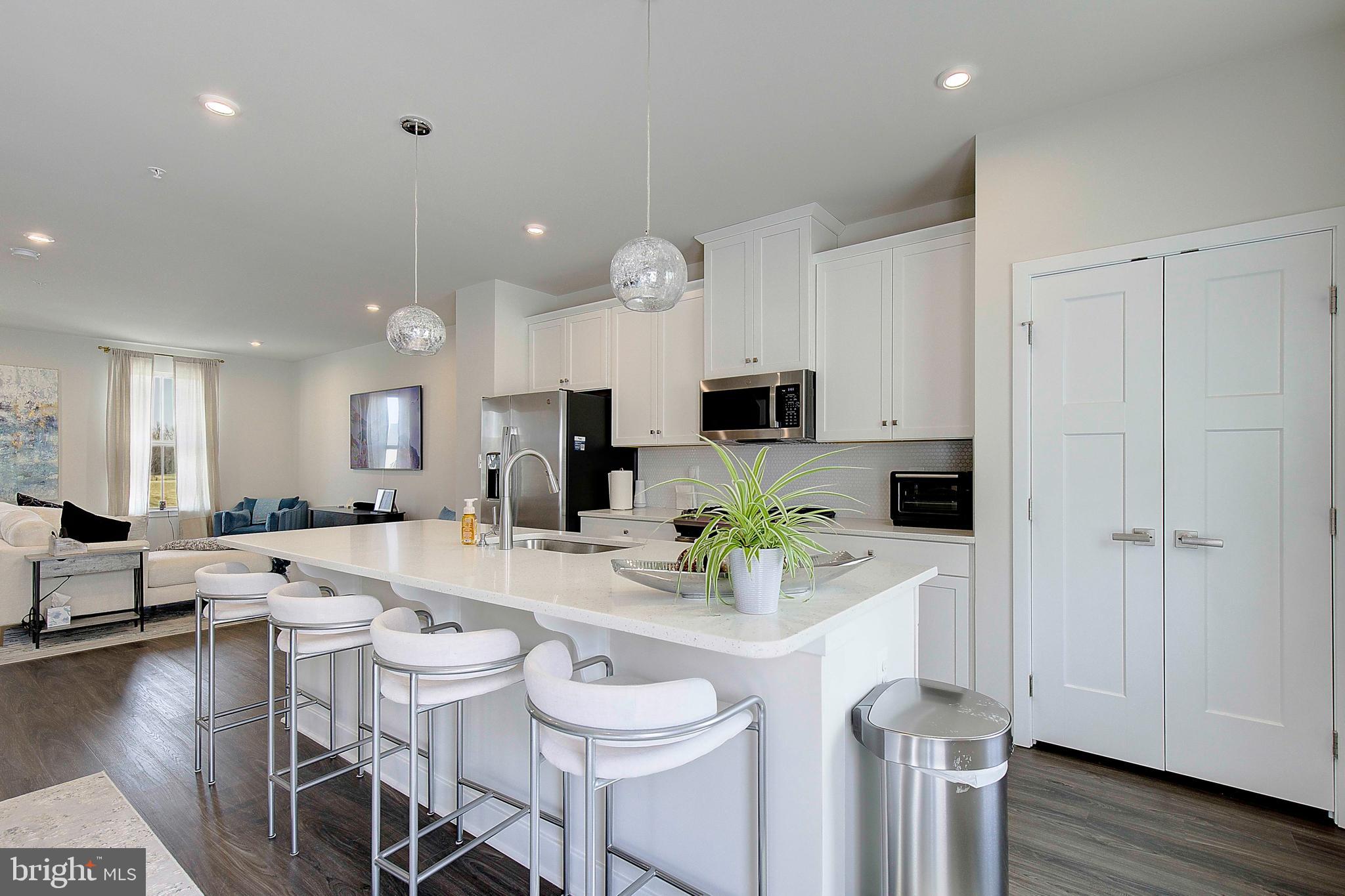 121 Swanson Creek Terrace Laurel, MD 20708 - Photo 17 of 31 a very nice looking open dining room with kitchen island furniture a wooden floor and a view of living room