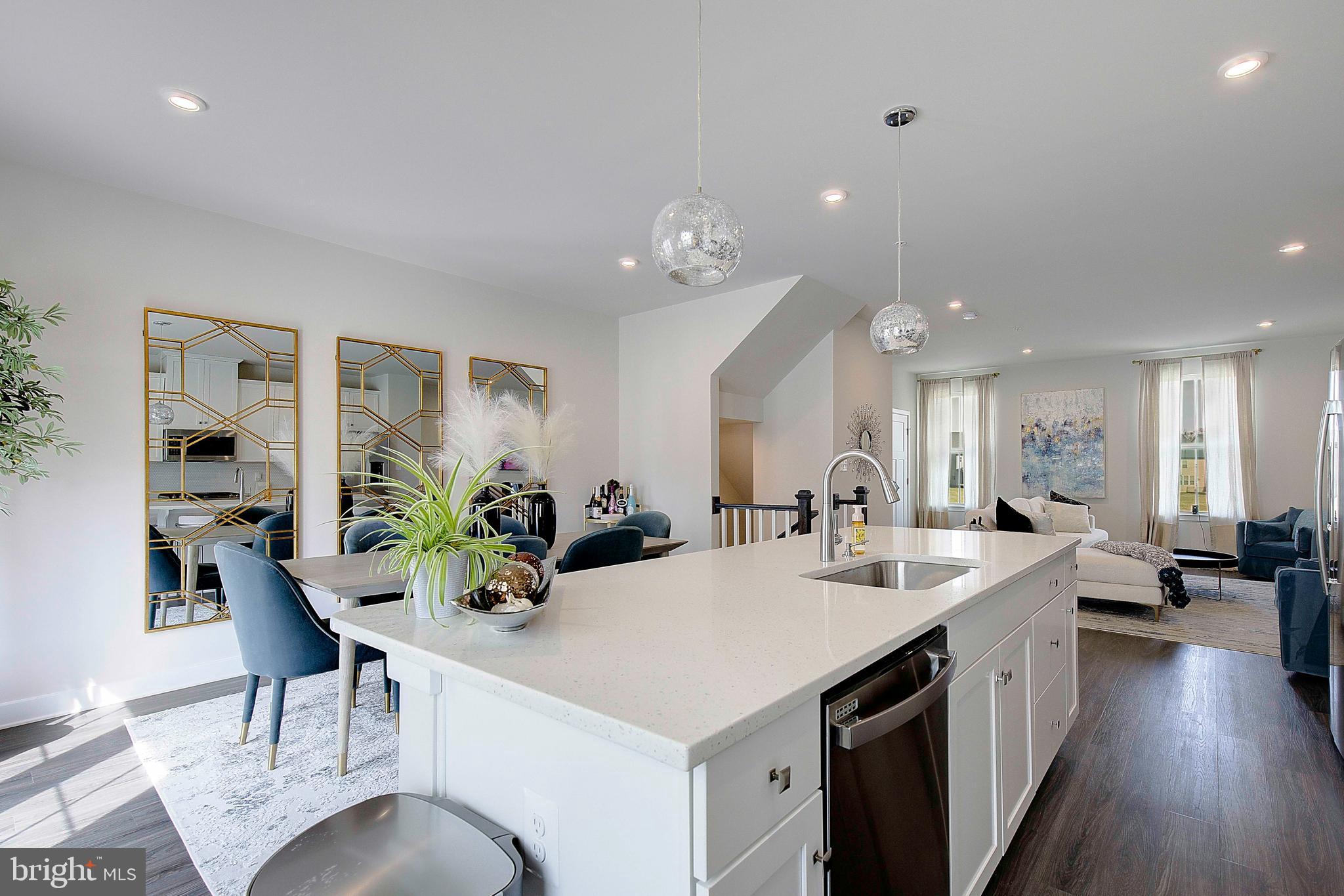 121 Swanson Creek Terrace Laurel, MD 20708 - Photo 18 of 31 a kitchen with sink refrigerator and dining table