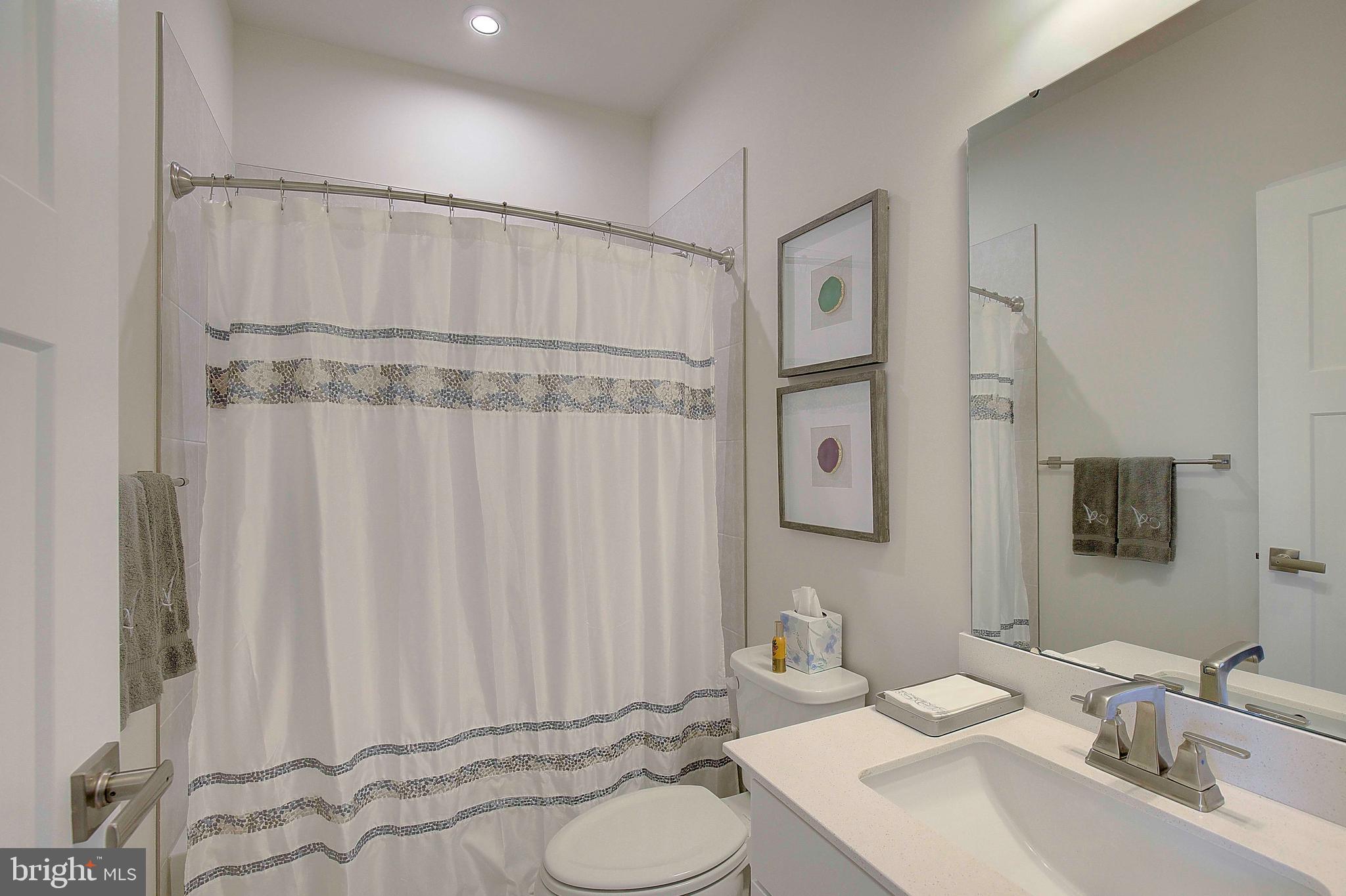 121 Swanson Creek Terrace Laurel, MD 20708 - Photo 21 of 31 a bathroom with a sink vanity mirror and tub