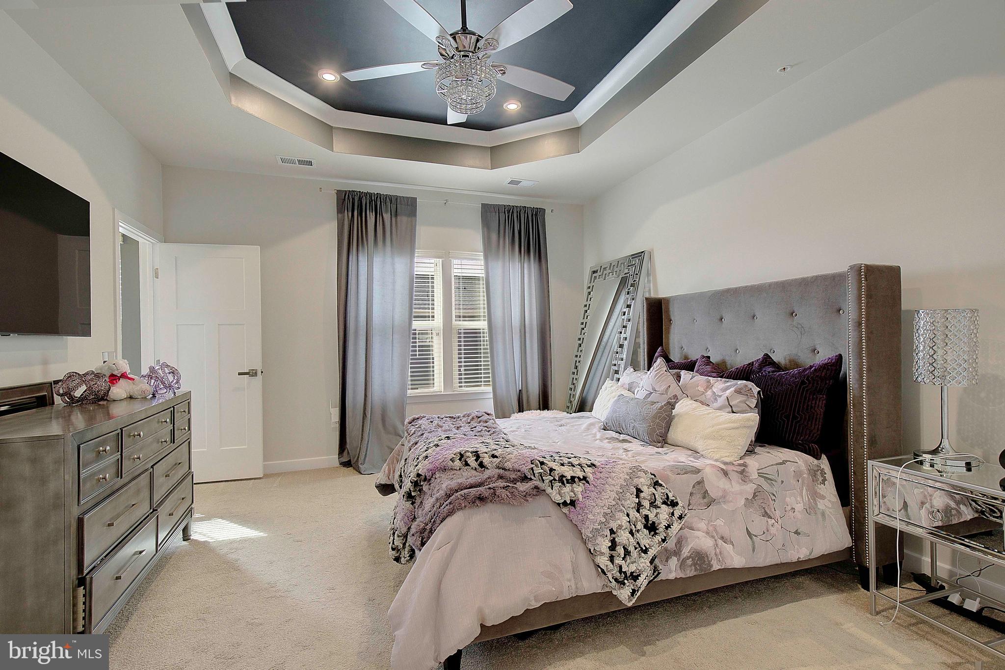 121 Swanson Creek Terrace Laurel, MD 20708 - Photo 24 of 31 a bedroom with a bed and a flat screen tv