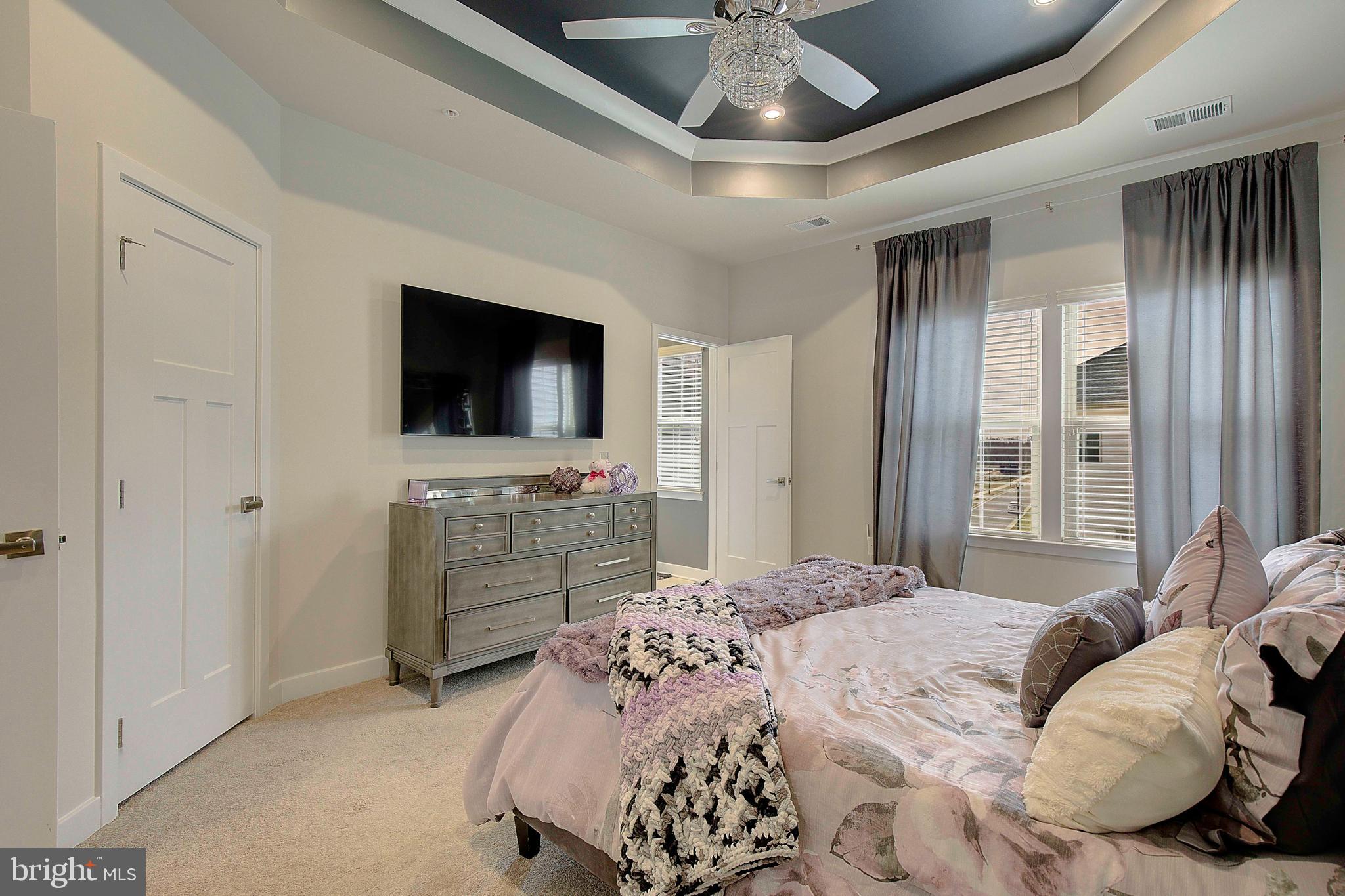 121 Swanson Creek Terrace Laurel, MD 20708 - Photo 25 of 31 a bedroom with a bed and a flat screen tv