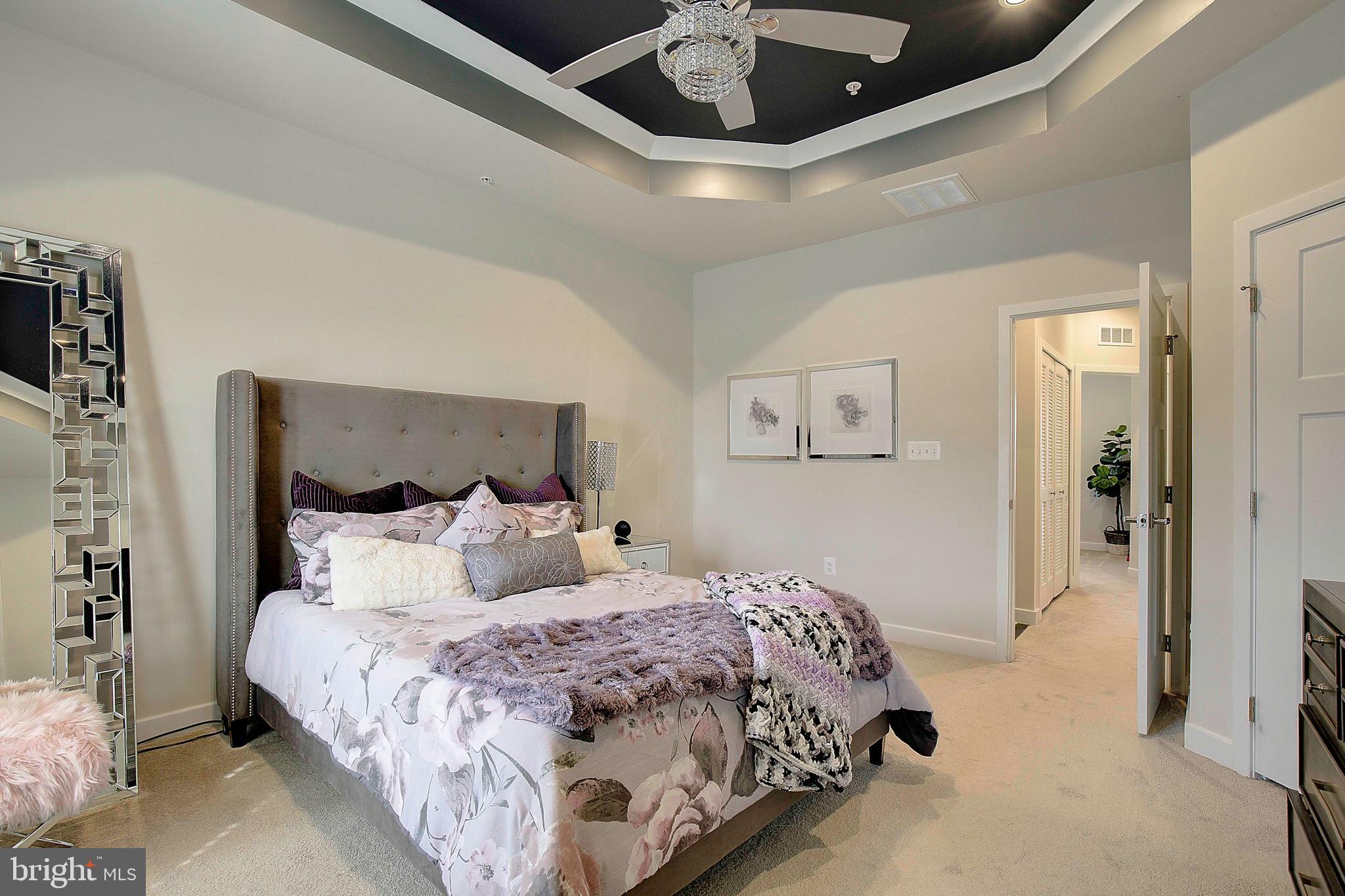 121 Swanson Creek Terrace Laurel, MD 20708 - Photo 27 of 31 a bedroom with a large bed and a chandelier