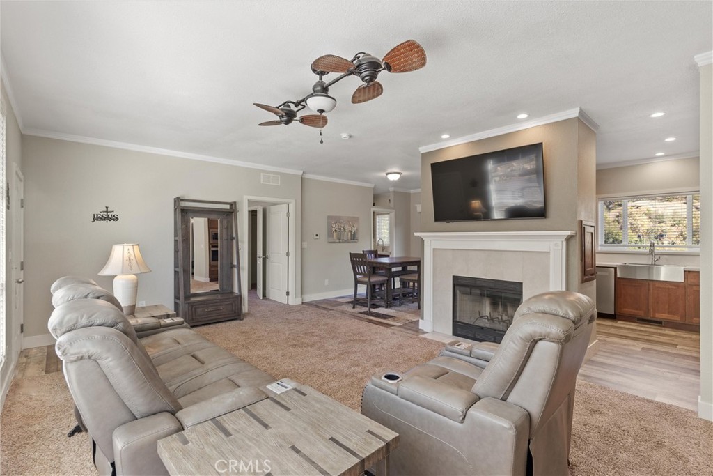 12656 Centerville Road Chico, CA 95928 - Photo 9 of 46 a living room with furniture a fireplace and a flat screen tv