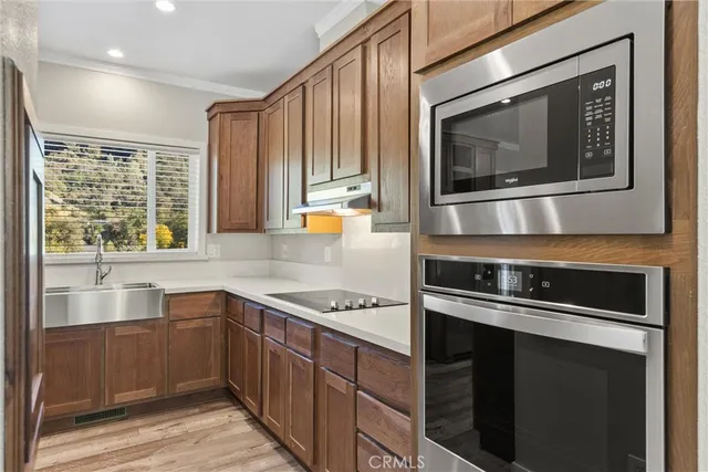 a kitchen with kitchen island a sink stove and refrigerator