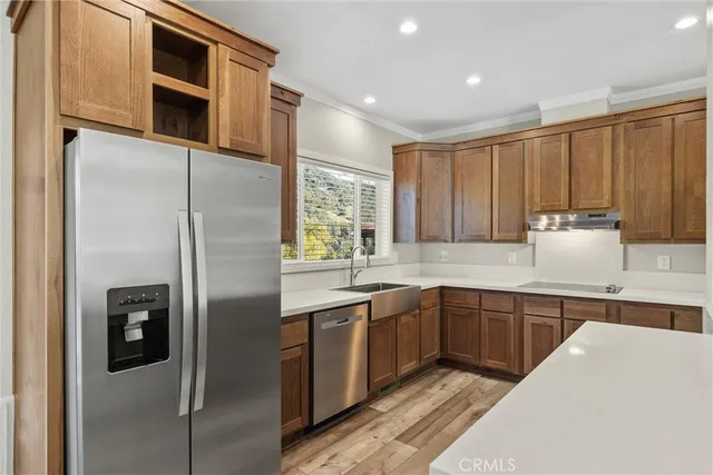 a kitchen with stainless steel appliances granite countertop a stove microwave and sink