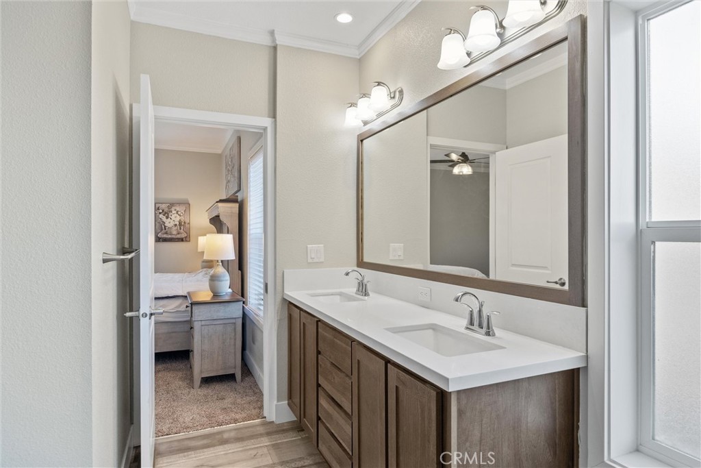 12656 Centerville Road Chico, CA 95928 - Photo 20 of 46 a en suite bathroom with a double vanity sink a mirror and a toilet