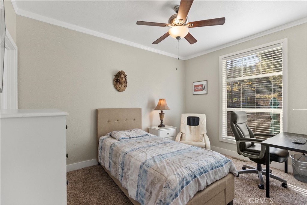 12656 Centerville Road Chico, CA 95928 - Photo 22 of 46 a bedroom with a bed a chair and a large window