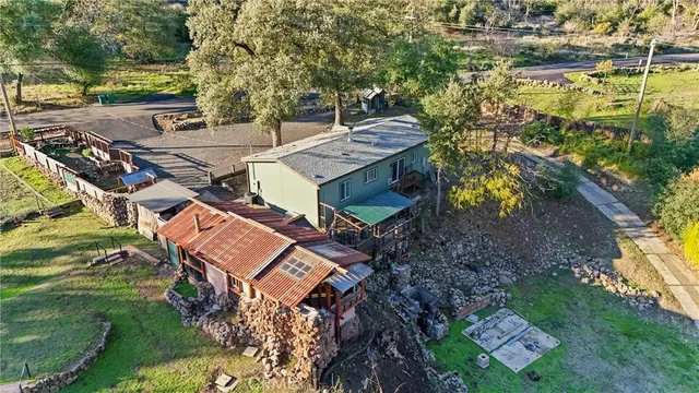 a view of a house with a yard and sitting area