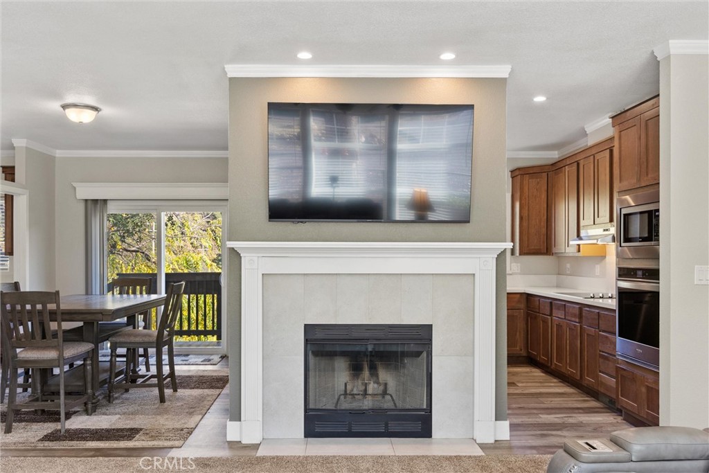 12656 Centerville Road Chico, CA 95928 - Photo 8 of 46 a living room with stainless steel appliances granite countertop a fireplace a sink dishwasher a oven and a dining table with wooden floor