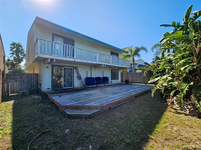 a view of house with backyard and sitting area