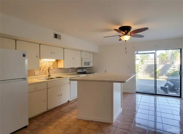 a kitchen with stainless steel appliances granite countertop a sink a counter space and cabinets