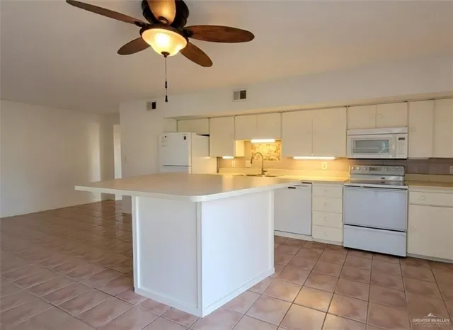 a kitchen with a cabinets and chandelier