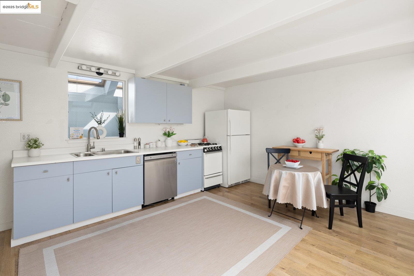 1450 Fourth Street, Unit 5 Berkeley, CA 94710 - Photo 7 of 18 a kitchen with a white cabinets and white appliances