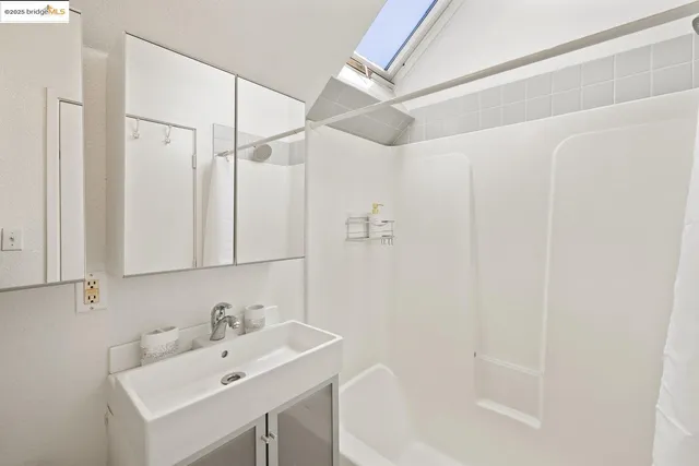 a bathroom with a sink a mirror and a shower