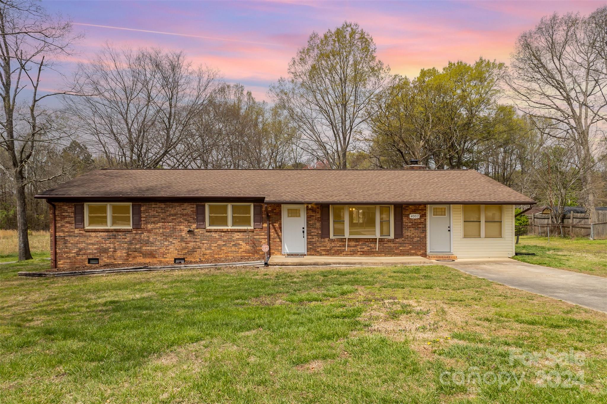 4007 Beaty Road Gastonia, NC 28056 - Photo 1 of 24 a front view of a house with a garden