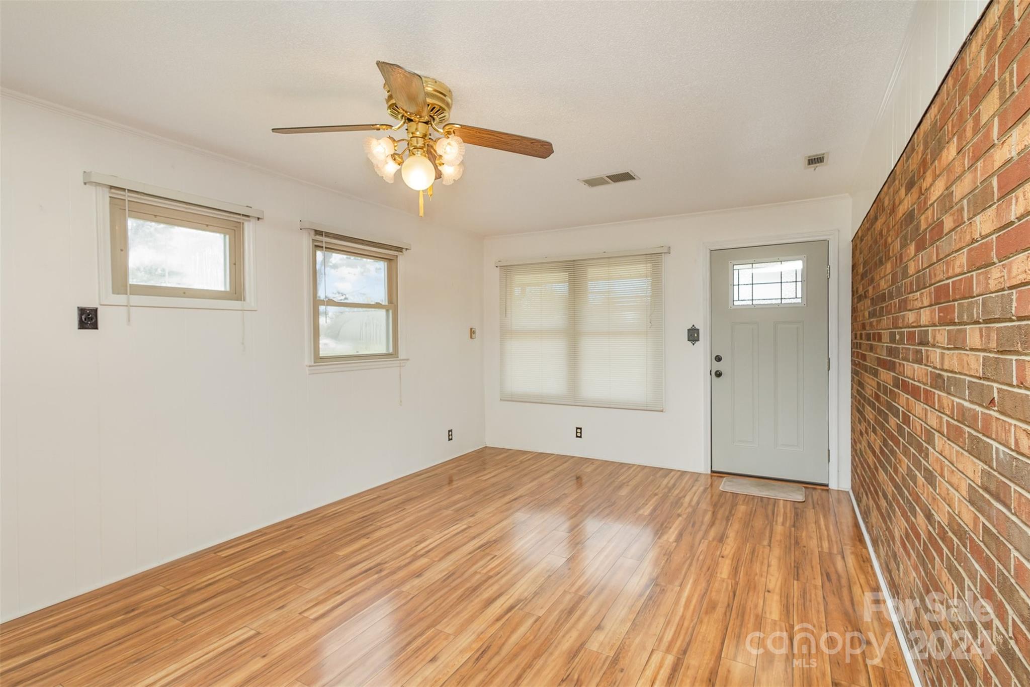 4007 Beaty Road Gastonia, NC 28056 - Photo 11 of 24 a view of an empty room with wooden floor and a window