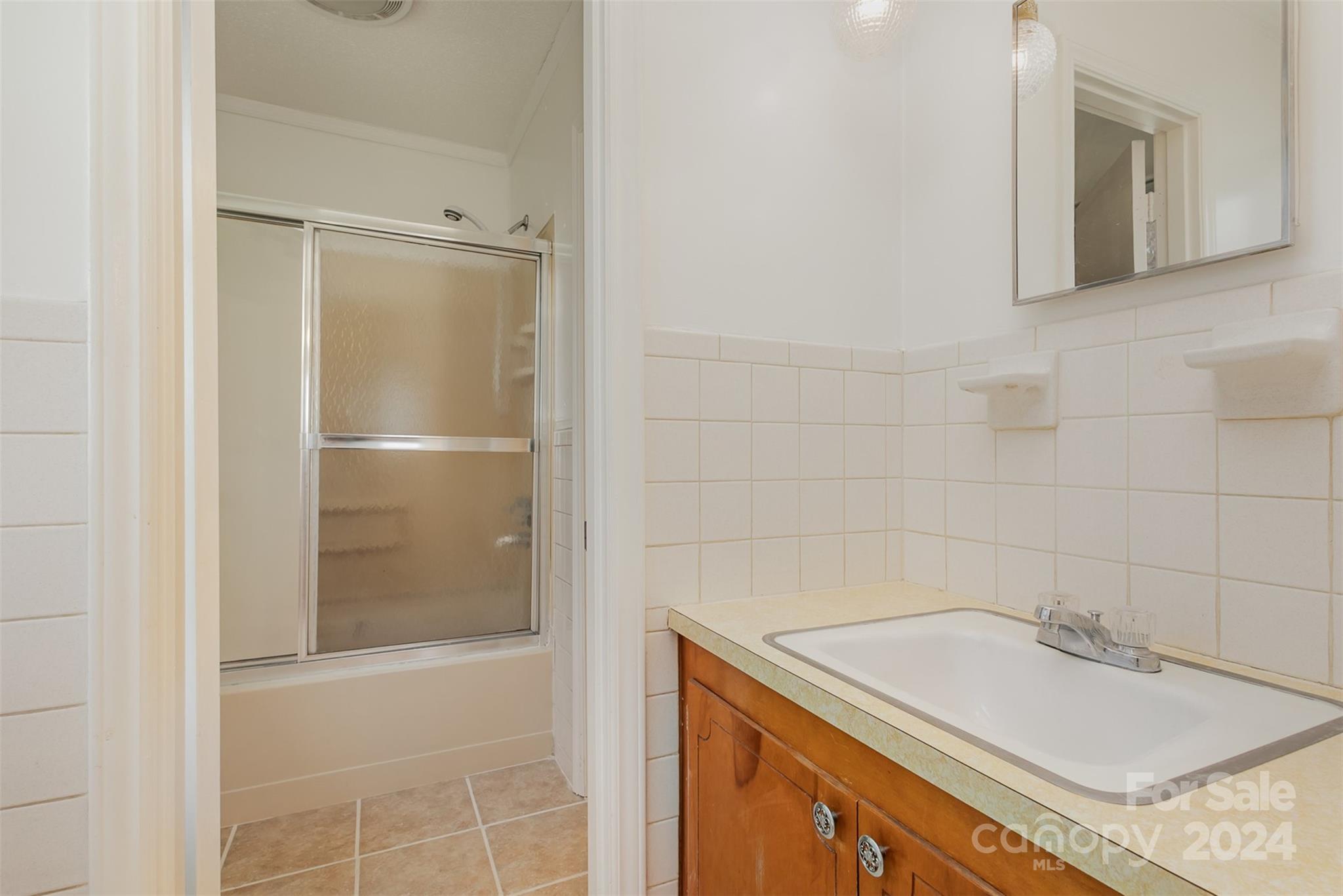 4007 Beaty Road Gastonia, NC 28056 - Photo 15 of 24 a bathroom with a granite countertop sink mirror and a shower