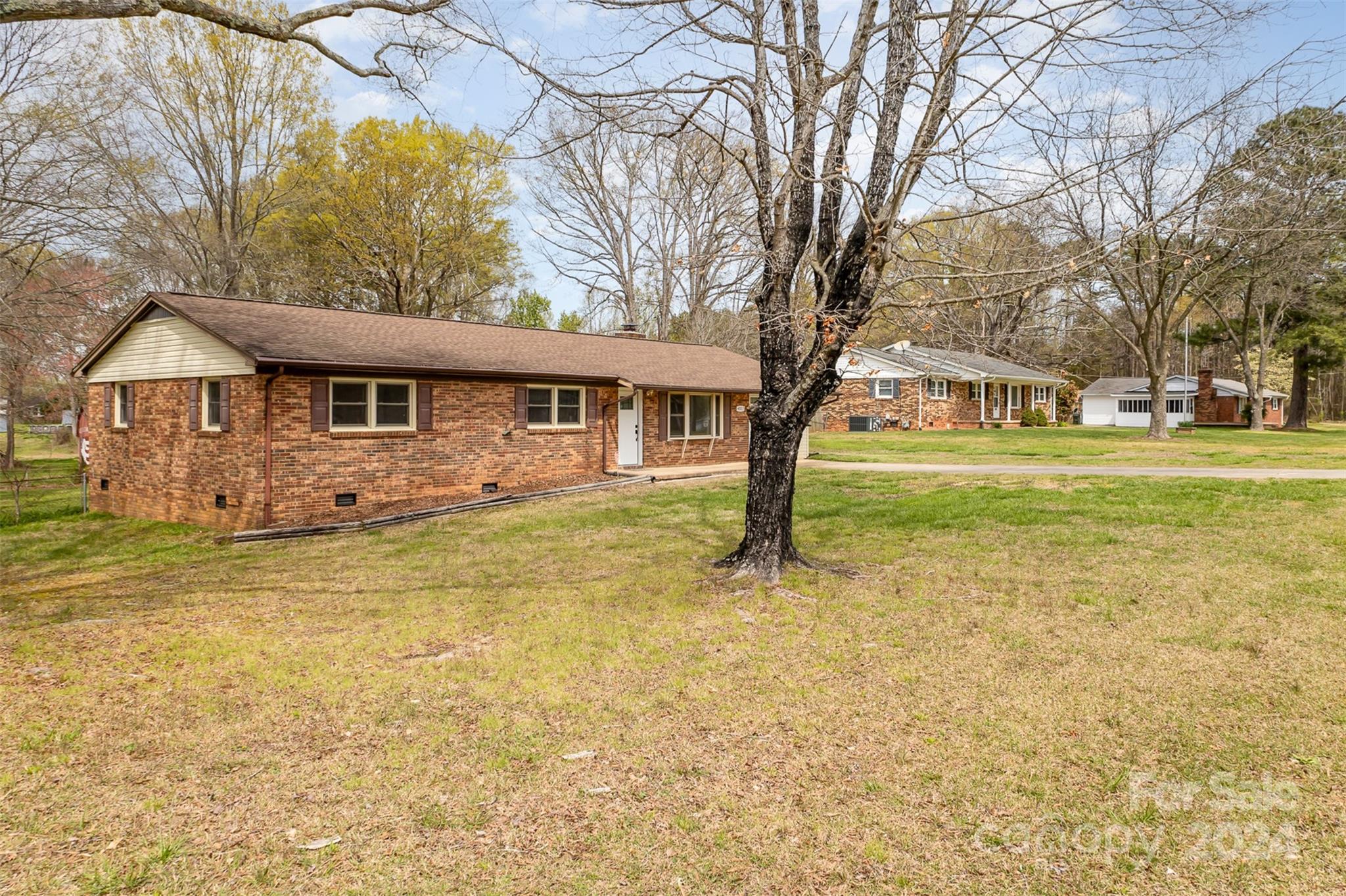 4007 Beaty Road Gastonia, NC 28056 - Photo 21 of 24 a front view of a house with a yard table and chairs