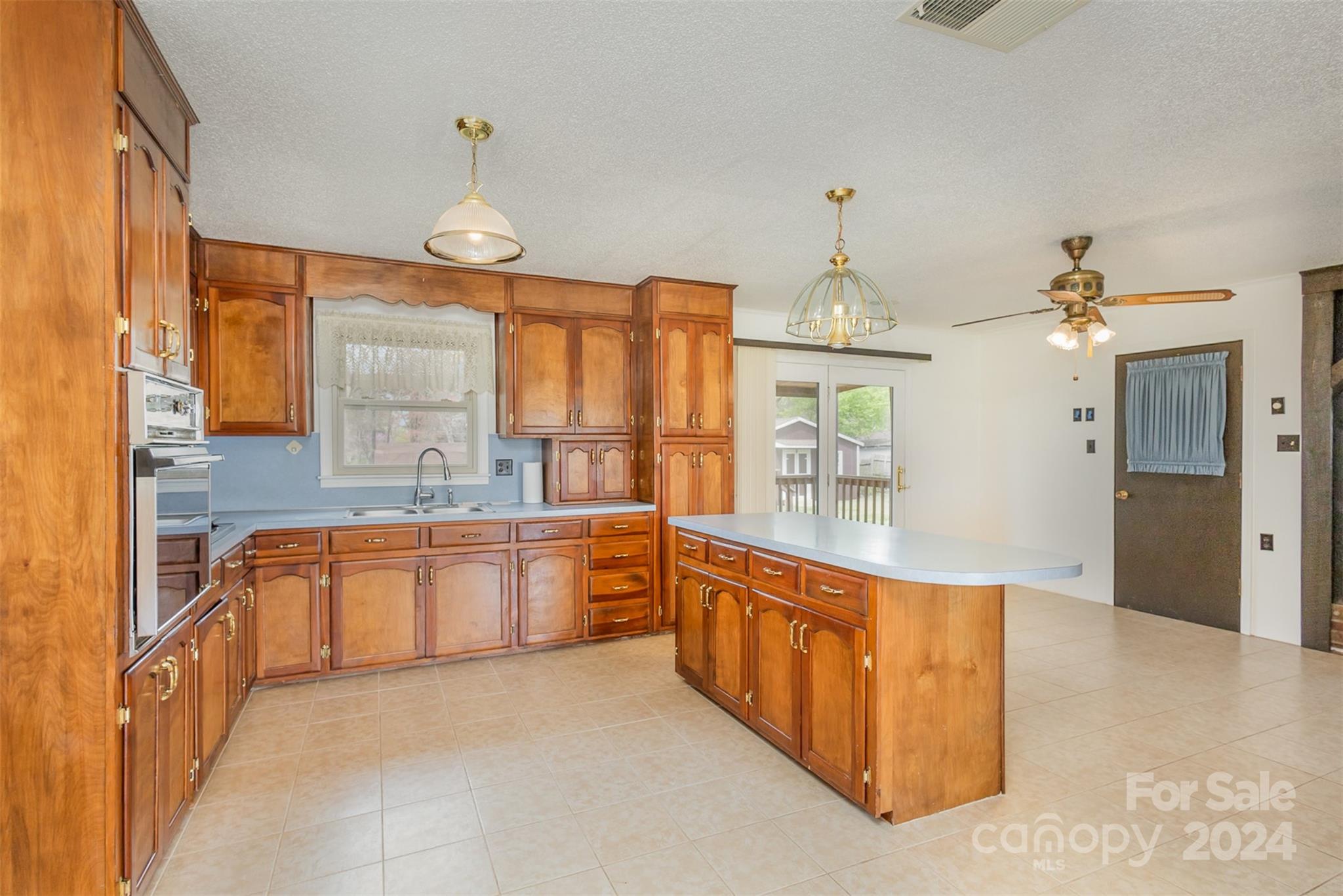 4007 Beaty Road Gastonia, NC 28056 - Photo 8 of 24 a large kitchen with granite countertop a stove oven and a sink with granite countertops