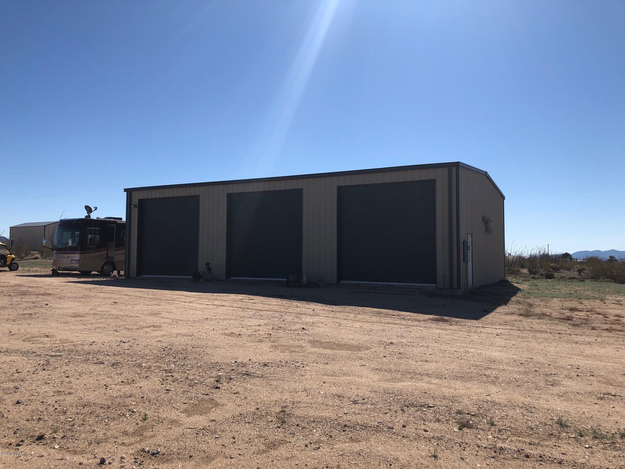 14106 Ashurst Road Yucca, AZ 86438 - Photo 1 of 17 a parking space with wooden fence