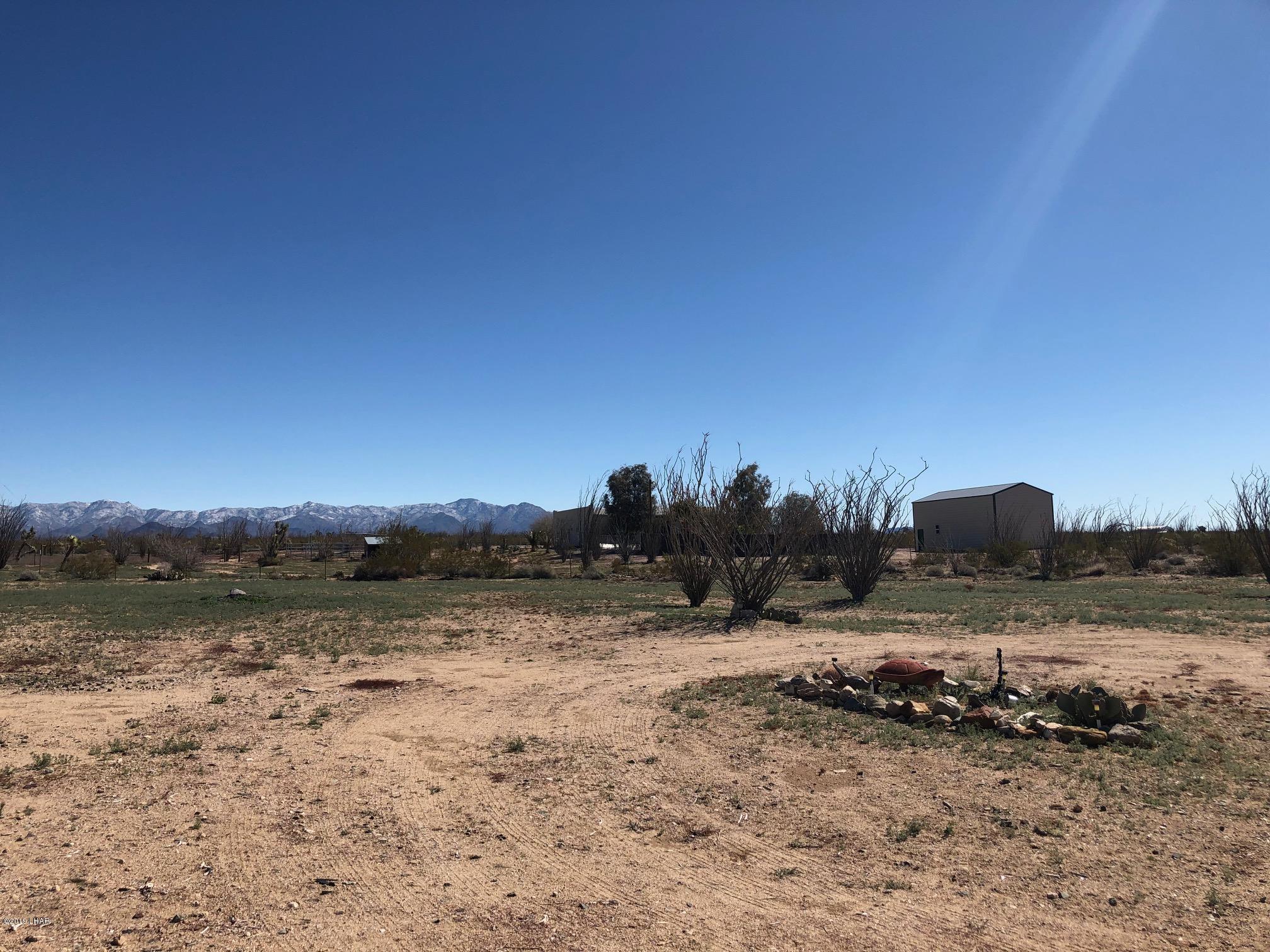 14106 Ashurst Road Yucca, AZ 86438 - Photo 12 of 17 a view of a lake with a mountain