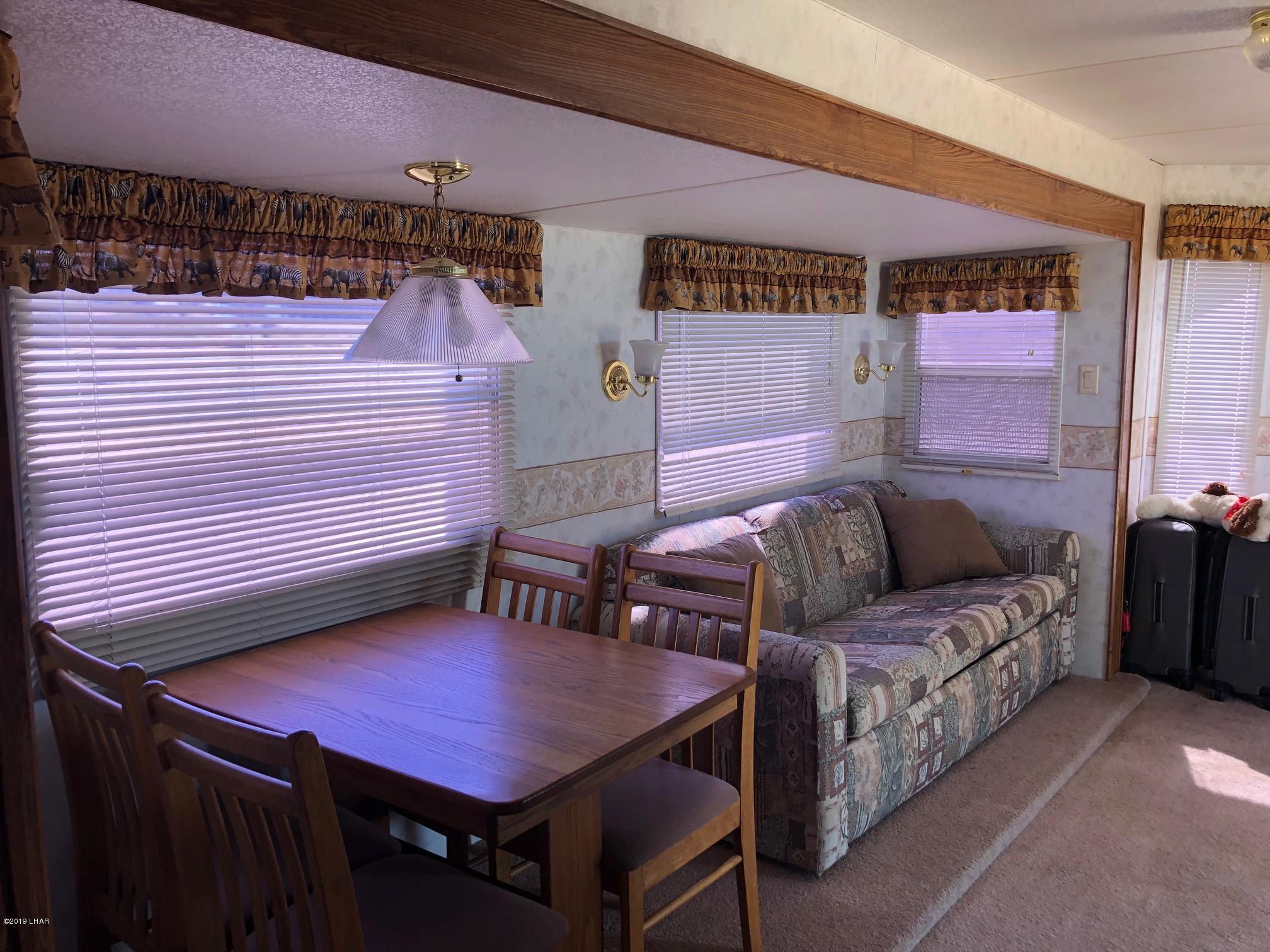 14106 Ashurst Road Yucca, AZ 86438 - Photo 3 of 17 a view of a balcony with table and chairs