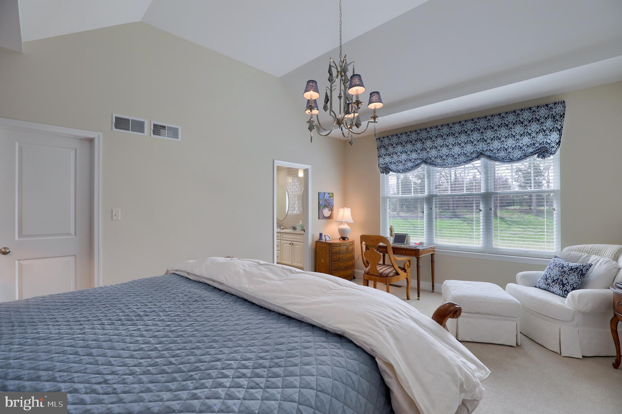 653 Dorset Street Lititz, PA 17543 - Photo 22 of 30 a bedroom with a large bed and a chandelier