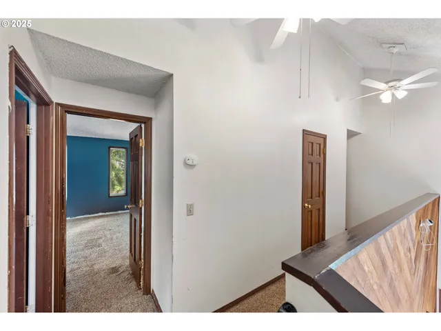 a view of a hallway with wooden floor and entryway