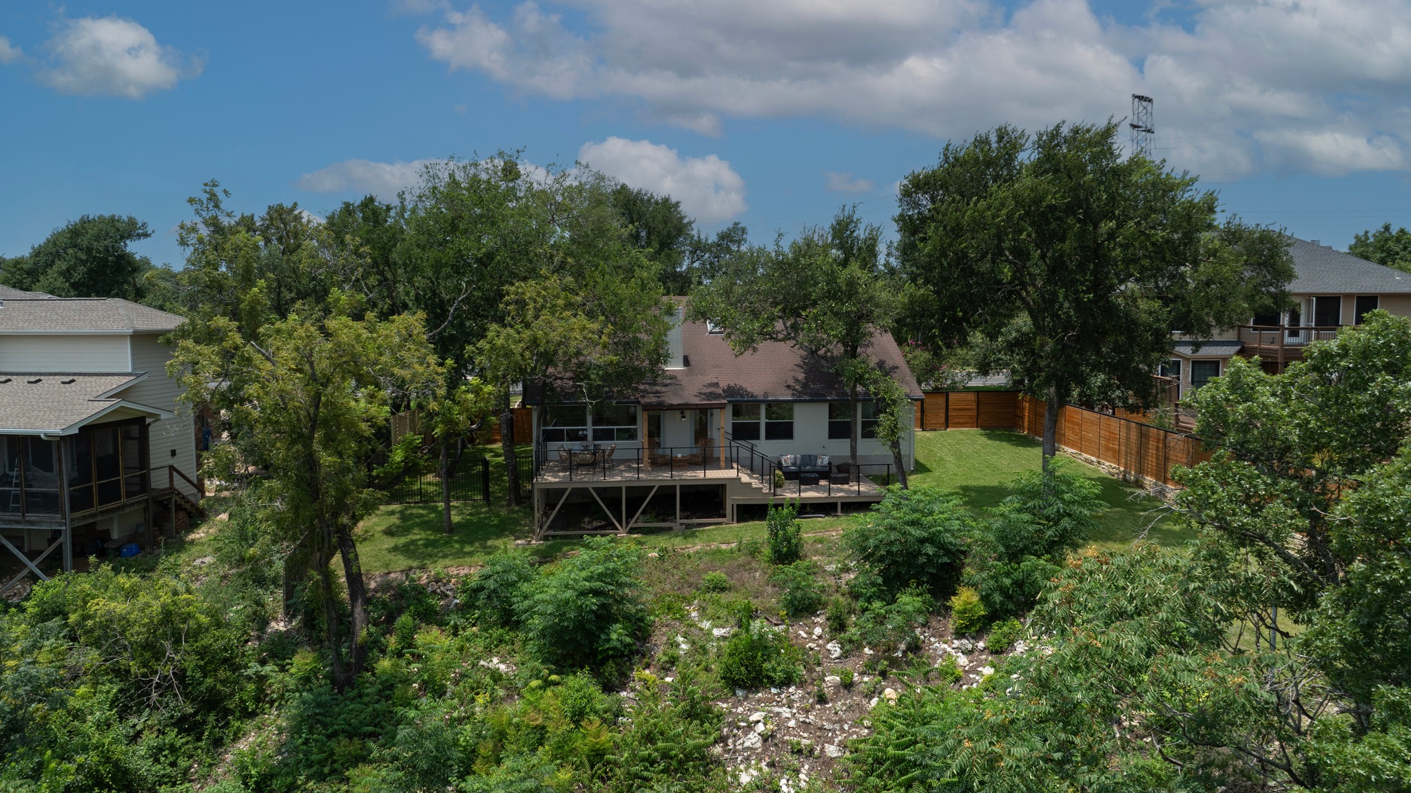 7705 Jester Boulevard Austin, TX 78730 - Photo 30 of 36 Perched on a verdant hillside, this charming residence features a broad deck overlooking a lush, private yard.