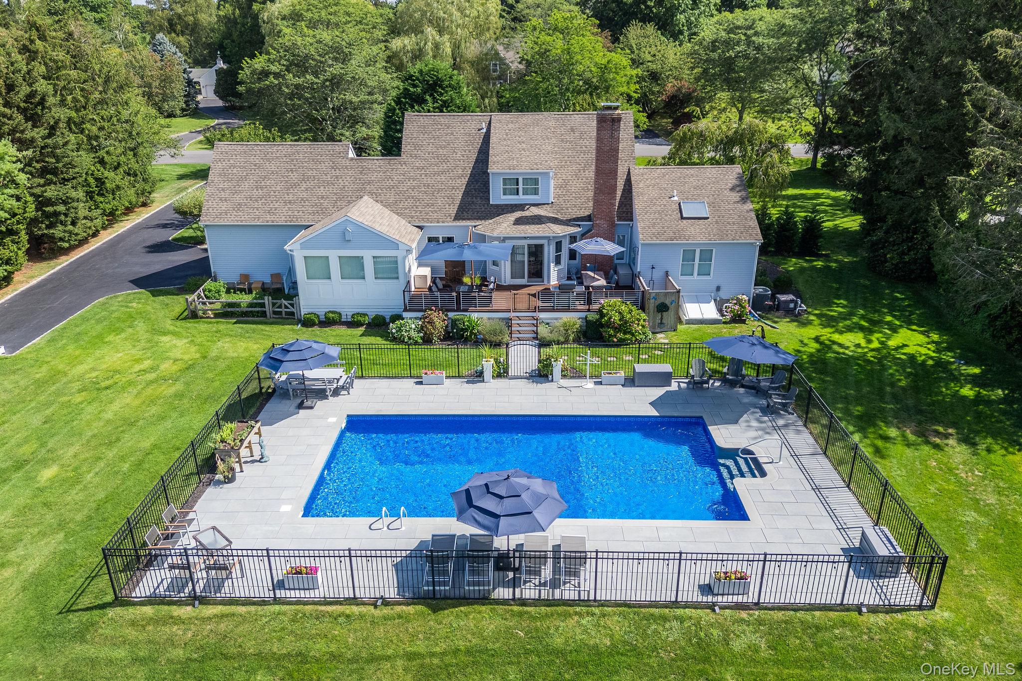 a aerial view of a house with table and chairs with a yard