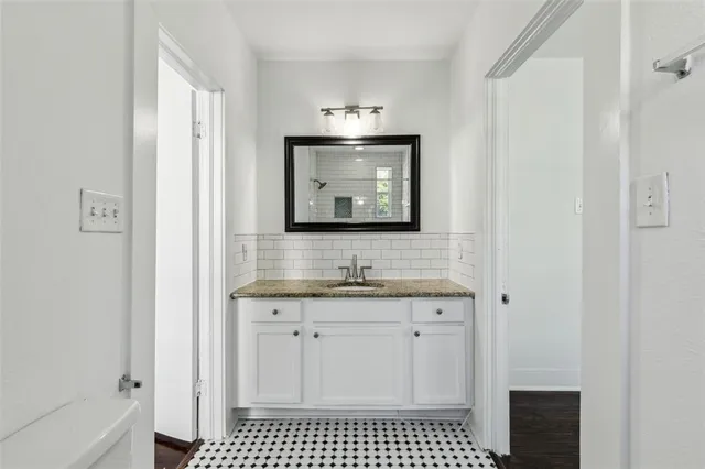 a bathroom with a sink a toilet and a mirror