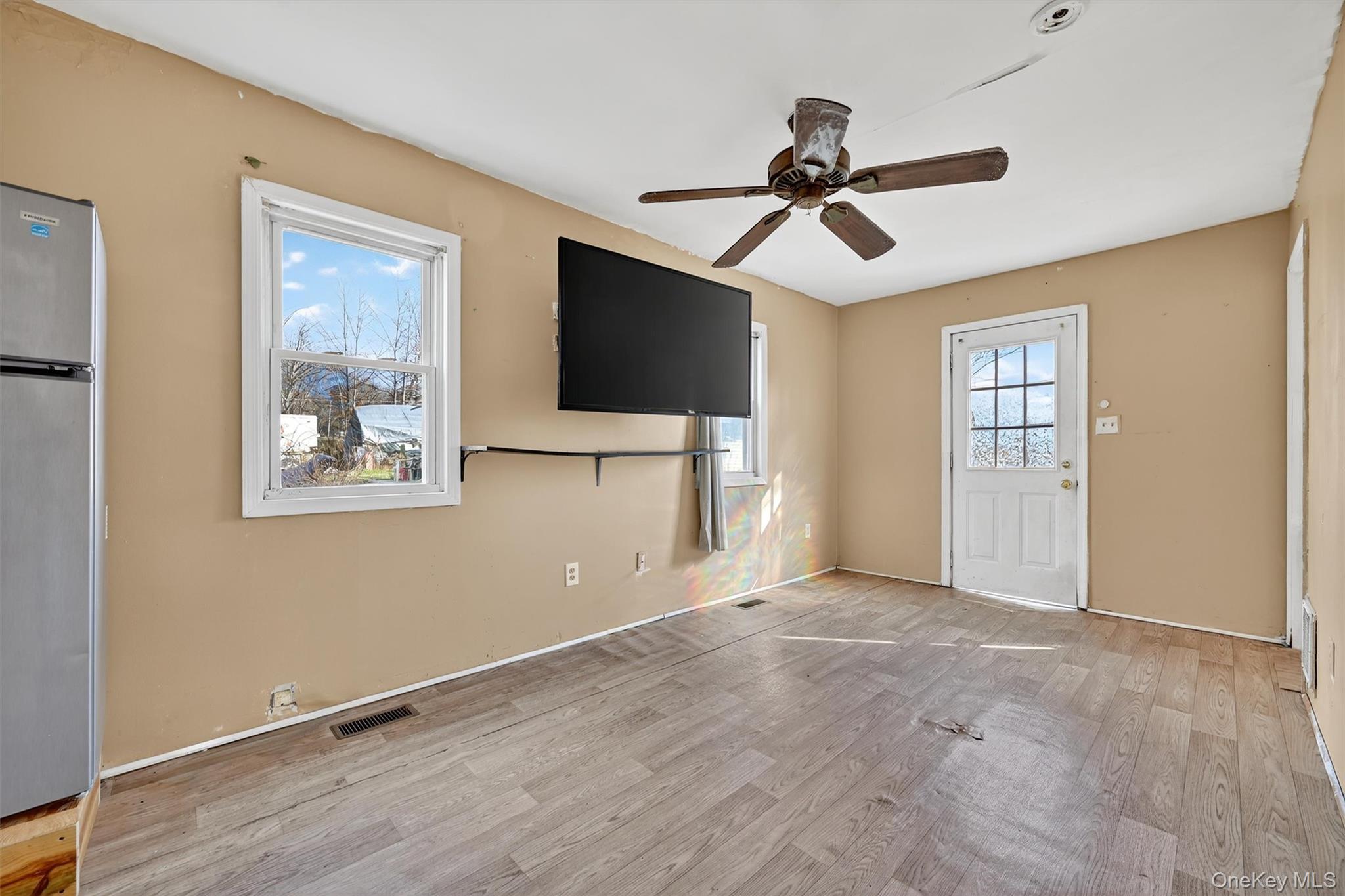 1187 Burlingham Road Pine Bush, NY 12566 - Photo 11 of 26 a view of an empty room with wooden floor and a window