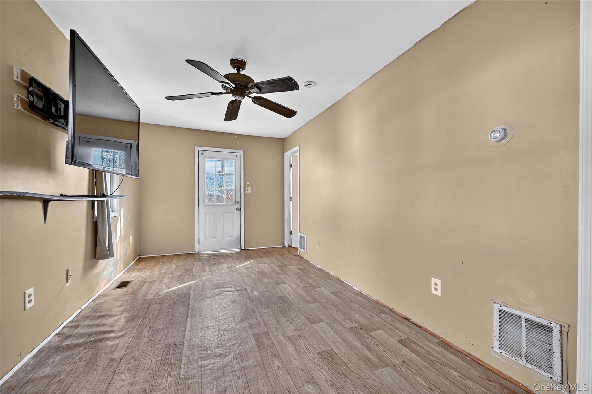 1187 Burlingham Road Pine Bush, NY 12566 - Photo 12 of 26 a view of empty room with wooden floor and fan