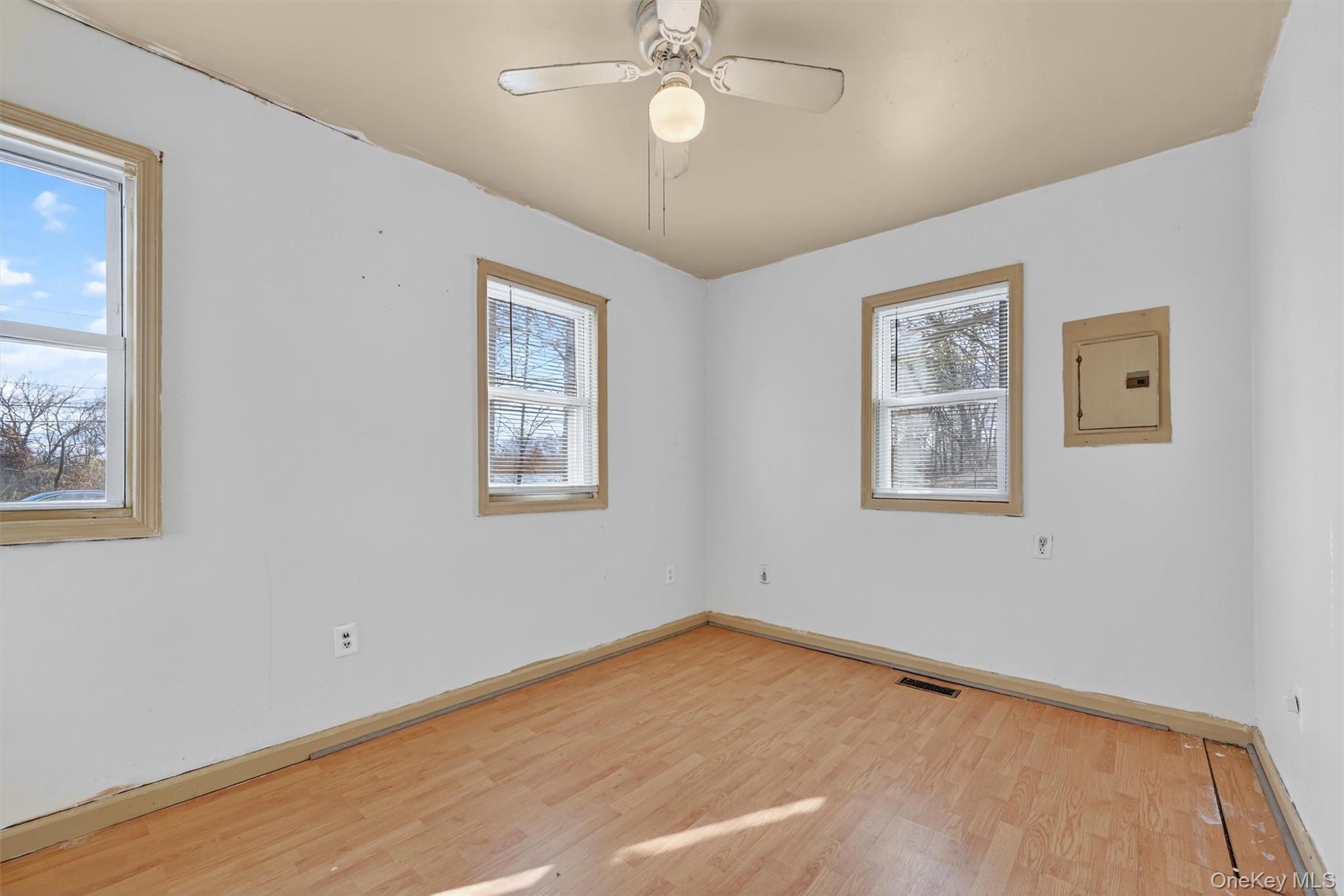 1187 Burlingham Road Pine Bush, NY 12566 - Photo 18 of 26 a view of a room with wooden floor and a ceiling fan
