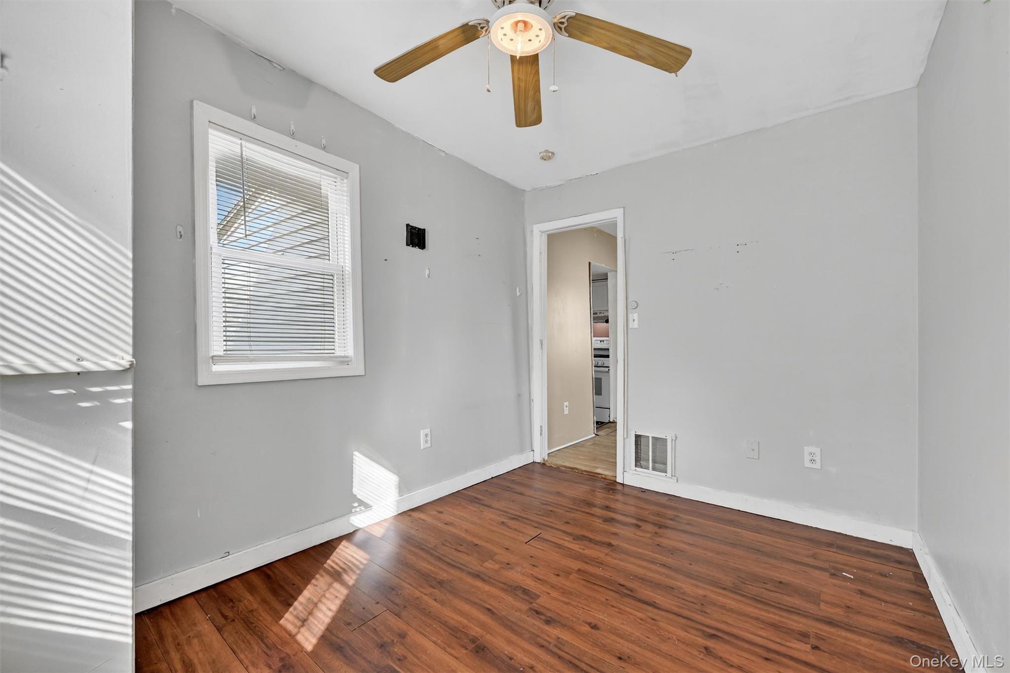1187 Burlingham Road Pine Bush, NY 12566 - Photo 23 of 26 wooden floor in an empty room with a window