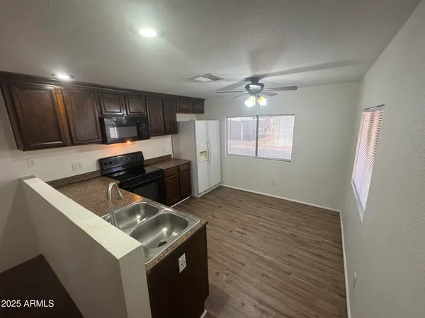 a kitchen that has a sink and a stove in it