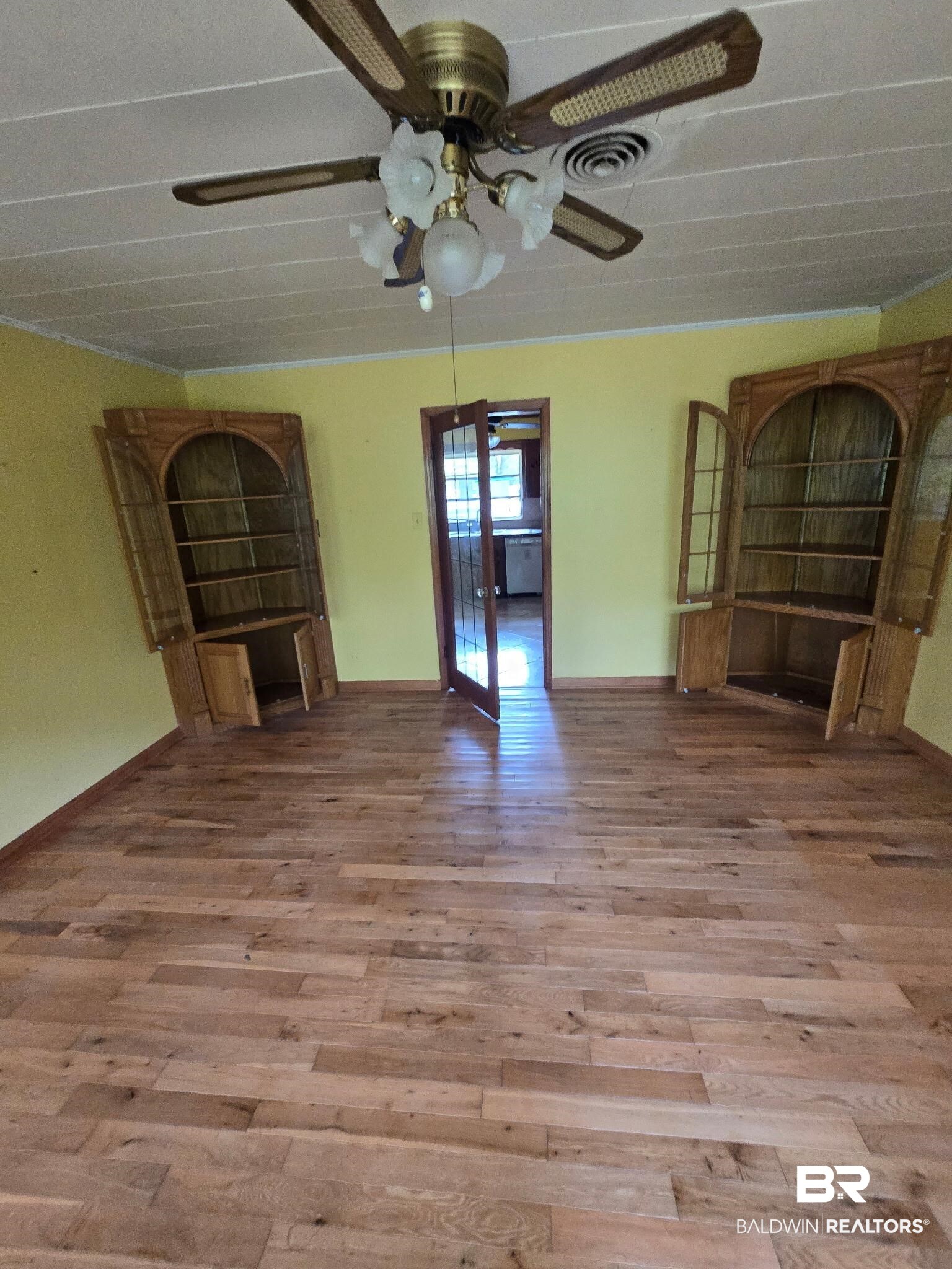 8731 Byrnes Lake Road Bay Minette, AL 36507 - Photo 4 of 14 Unfurnished living room featuring visible vents, baseboards, wood finished floors, and ceiling fan