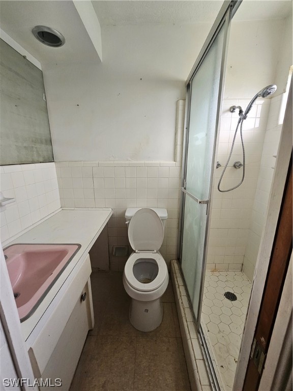 Undisclosed Address Lehigh Acres, FL 33936 - Photo 12 of 15 a bathroom with a granite countertop toilet a sink and a shower