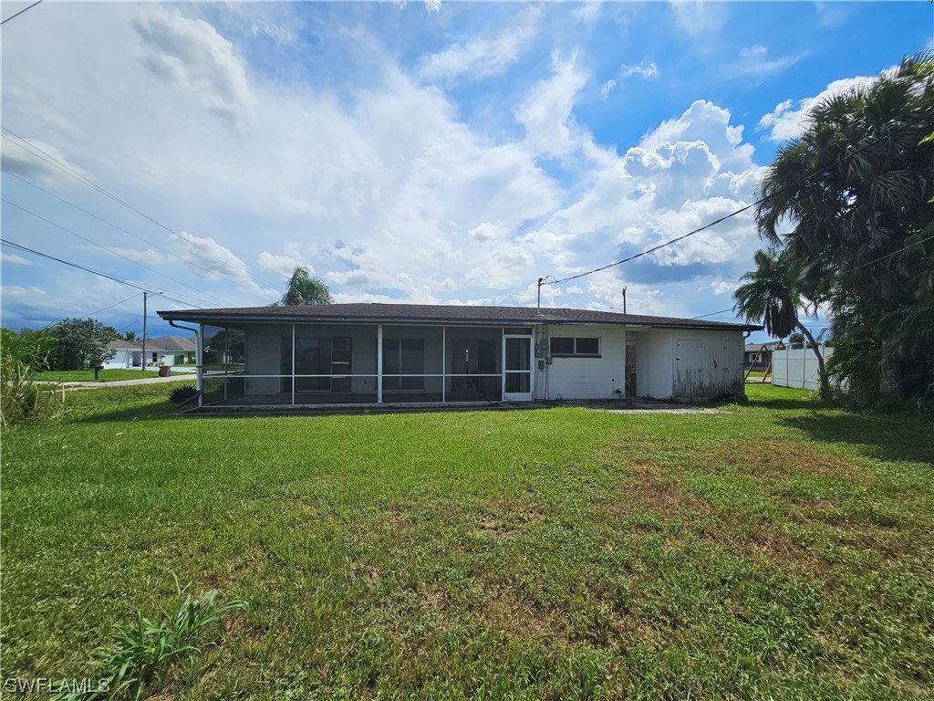 Undisclosed Address Lehigh Acres, FL 33936 - Photo 2 of 15 a front view of a house with garden