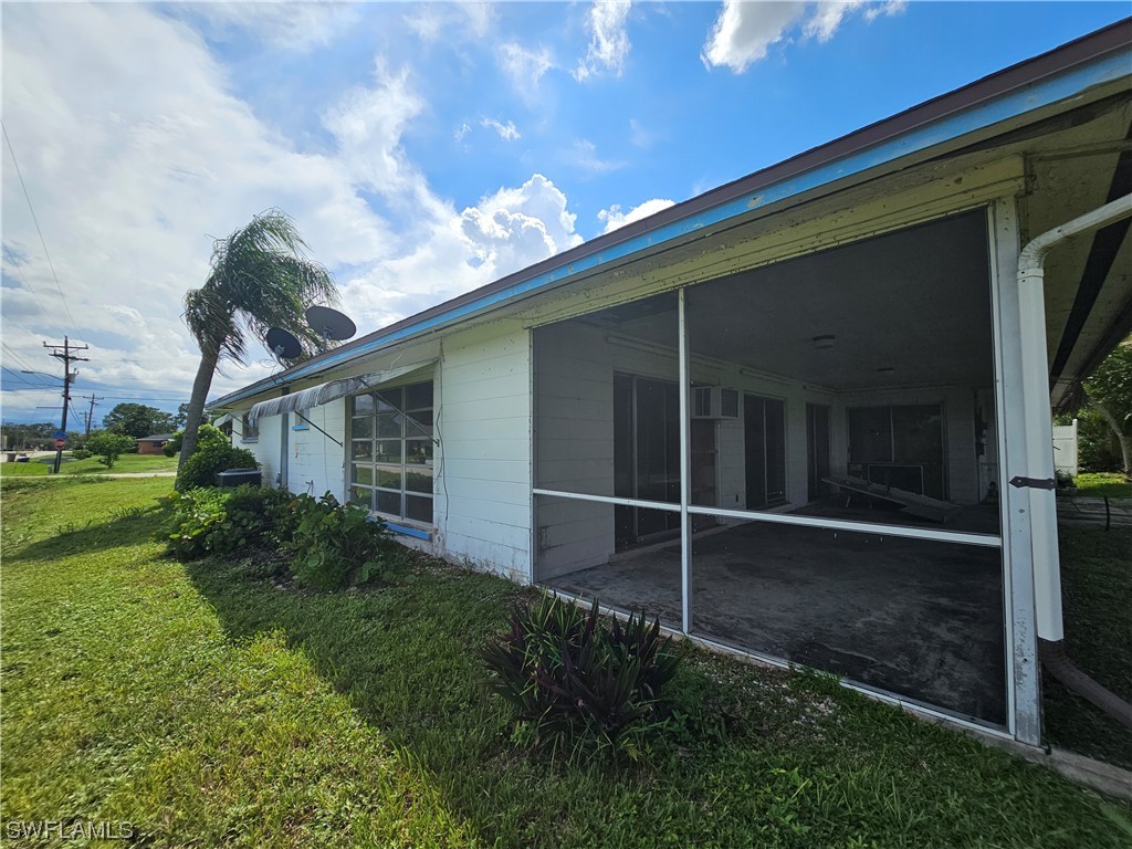 Undisclosed Address Lehigh Acres, FL 33936 - Photo 4 of 15 a backyard of a house with plants and outdoor seating